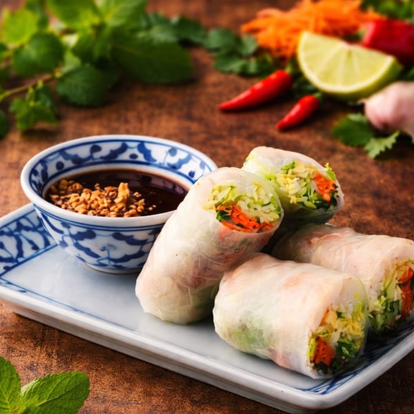 Fresh spring rolls with vegetables and shrimp, served with a peanut dipping sauce.